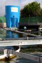 Experimental microalgae production system in the wastewater treatment of Chiclana. In the foreground a raceway pond of 32 m2 and in the background a settler for biomass separation.